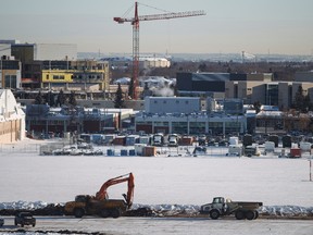 Construction crews work on the runway at the Blatchford redevelopment site in Edmonton, Alta., on Wednesday, Dec. 3, 2014. Construction materials are being recycled from the old City Centre Airport site as it's redeveloped over 26 years into an environmentally friendly multi-use community. Ian Kucerak/Edmonton Sun/QMI Agency
