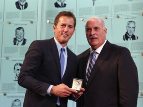 TORONTO, ON - NOVEMBER 14: John Davidson (R), Chairman of the Hockey Hall of Fame Selection Committee presents the Hall of Fame ring to 2014 Mike Modano (L) during a photo opportunity at the Hockey Hall of Fame on November 14, 2014 in Toronto, Canada.   Bruce Bennett/Getty Images/AFP== FOR NEWSPAPERS, INTERNET, TELCOS & TELEVISION USE ONLY ==