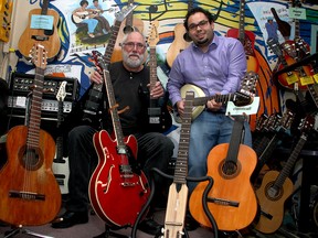 Joe's Music Instrument Lending Library librarian Roger Eccleston, left, and board member Ricardo Giuliani , at the Library in the Robert Meek Youth Community Centre.  (Ian MacAlpine/The Whig-Standard)