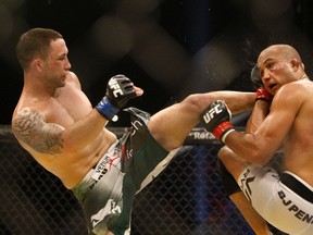 Frankie Edgar of the U.S. (left) strikes compatriot BJ Penn with a high kick during their bout in the Ultimate Fighting Championship tournament in Abu Dhabi April 10, 2010. (REUTERS/Mohammed Salem)