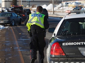 A damaged Chrysler Intrepid car is towed on Sherwood Park west of 17 Street on Wednesday. (IAN KUCERAK/EDMONTON SUN)