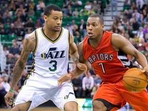 Raptors guard Kyle Lowry (right) drives around Utah Jazz defender Trey Burke during the first half of their game on Wednesday night. (USA Today Sports)