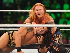 Heath Slater (top) chokes his opponent during their WWE Smack Down match at The Scotiabank Place in Ottawa on Sept. 11, 2012. (Matthew Usherwood/QMI Agency/Files)