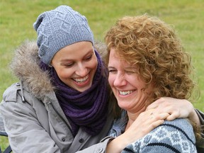 Taylor Bertelink, 18, laughs with her mother, Cathie, outside their home in Foxboro, Ont. Thursday, November 27, 2014. Taylor has osteosarcoma, a form of bone cancer, and is undergoing chemotherapy prior to surgery to remove her right shoulder blade to stop the growth of a tumour. But she remains positive and encourages others in her situation to do the same. - Luke Hendry/The Intelligencer/QMI Agency
