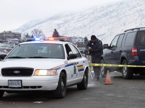 Police investigators attend the scene of an early morning shooting of a Royal Canadian Mounted Police (RCMP) officer in British Columbia on December 3, 2014. (REUTERS/Andrew Snucins)