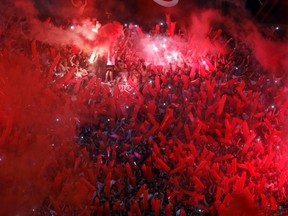 River Plate's fans light flares as they cheer before the Copa Sudamericana second leg semi-final soccer match against Boca Juniors in Buenos Aires November 27, 2014. (REUTERS/Enrique Marcarian)