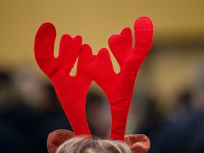 Eight-year volunteer Louise Lebel wore a pair of brightly coloured reindeer ears as she worked the intake line during the Christmas Bureau of Edmonton's Walk-In Days held at Amiskwaciy Academy in Edmonton, Alta., on Sunday, Dec. 22, 2013. Walk-In Days, which allow those who haven't been able to access the Bureau's services to do so, continue through Monday, Dec. 23. Ian Kucerak/Edmonton Sun/QMI Agency