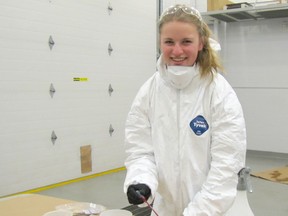 Hannah Symington, a 15-year-old Grade 10 student at LCCVI in Petrolia poses with a vial of sheep's blood students were using for experiments during a visit to the OPP forensic identification lab in Chatham on Dec. 4.