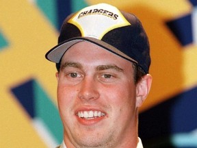 Former Washington State University quarterback Ryan Leaf wears the cap of the San Diego Chargers after Leaf was selected by the Chargers as the second overall pick in the 1998 NFL Draft in New York, April 18. (QMI Agency Files)
