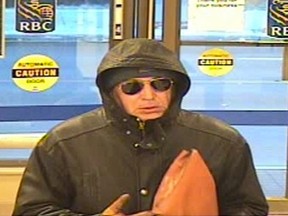 Police released this image of a "well dressed" gun-toting bandit who held up four banks in Toronto.