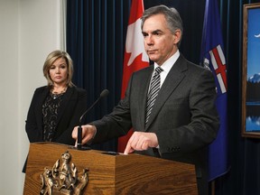 Premier Jim Prentice speaks alongside Calgary North-West MLA Sandra Jansen about the suspending of Bill 10 during a press conference at the Alberta Legislature in Edmonton, Alta., on Thursday, Dec. 4, 2014. Ian Kucerak/Edmonton Sun/ QMI Agency