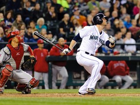 Michael Saunders hits a RBI sacrifice fly on May 30, 2014, at Safeco Field in Seattle. (STEVEN BISIG/USA TODAY Sports)