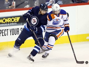 Oilers head coach Dallas Eakins says the team's offensive players, including Jordan Eberle, shown here battleing Jets forward Evander Kane for the puck Wednesday, will see their scoring touch return. (USA TODAY SPORTS)