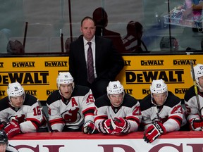 New Jersey Devils head coach Peter DeBoer stands behind his team's bench. (PIERRE-PAUL POULIN/QMI Agency files)