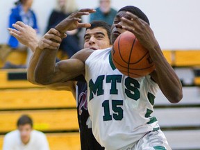 MTS point guard Bleska Kambamba fights for an offensive rebound with STA's Matt MacFarlane during their TVRA District Conference senior boys basketball game at Mother Teresa on Thursday. Kambamba didn?t miss much on the offensive end, leading the Spartans to a 61-41 victory with 26 points. (Mike Hensen/The London Free Press)