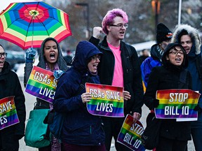 Protesters demonstrate against Bill 10 during the Alberta Legislature's Christmas light up event in Edmonton, Alta., on Thursday, Dec. 4, 2014. The controversial bill, which deals with student-led Gay-Straight Alliances, was put on hold for more consultation. (Codie McLachlan/Edmonton Sun/Postmedia Network)