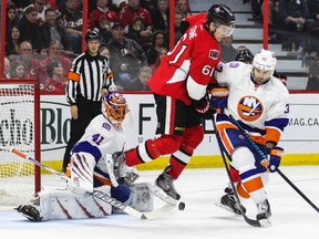 Ottawa Senators' Mark Stone jumps in front of New York Islanders' netminder Jaroslav Halak as Brian Strait defends during NHL hockey action at the Canadian Tire Centre in Ottawa, Ontario on Thursday December 4, 2014. Errol McGihon/Ottawa Sun/QMI Agency