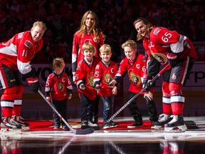 Daniel Alfredsson and his family, wife Bibbi and four sons, Hugo, Loui, Fenix and William Erik, perform a ceremonial faceoff with Sens captain Erik Karlsson at the Canadian Tire Centre in Ottawa after he skated with the team in warmup for one last time. December 4, 2014. Errol McGihon/Ottawa Sun/QMI Agency
