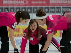Joanne Courtney, right, shown here sweeping for skip Rachel Homan Thursday at the Canada Cup in Camrose, joined the team with the support of her husband Mark. (Michael Burns, CCA)