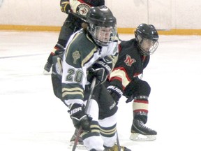 Nolan Riley of the St. Pat's Fighting Irish protects the puck from Aiden Manery of the Northern Vikings, with Viking Brett Barnes behind them near the blue line. Riley scored a goal, but the Irish fell 4-1 to the Vikings in Lambton Kent high school boys hockey at Clearwater Arena. (TERRY BRIDGE/THE OBSERVER)​
