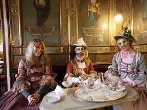 Masked revellers pose inside Caffe' Florian coffee shop in Saint Mark's Square during the Venetian Carnival in Venice in this February 27, 2011 file photo. If you find the crowds that swirl around St Mark's Square and the Rialto a little dismaying, why not take a look at Venice through the eyes of a different type of visitor -- the writers who have haunted its canals and palazzos.    REUTERS/Manuel Silvestri/Files