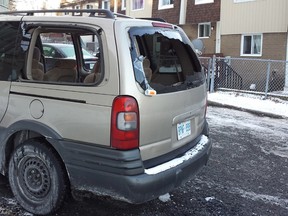 A van sits in a Penny Dr. driveway after having its windows shot out during what residents called a gunfight Thursday night in the Britannia townhome complex. Two men suffered gunshot wounds and are in hospital. (COREY LAROCQUE Ottawa Sun)