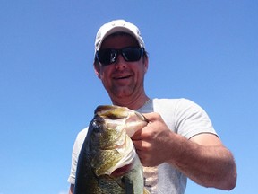 On The Wall Fishing tournament member Andrei 'Flipcast' Poryckyj shows off the leading largemouth bass for 2014, a 6-pound, 2-ounce, 21.5-inch long behemoth caught on July 18 somewhere in Zone 10.