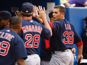 Kevin Cash (right) celebrates with his teammates during MLB game between Boston Red Sox and Toronto Blue Jays in Toronto, July 9, 2010.  (QMI Agency file photo)