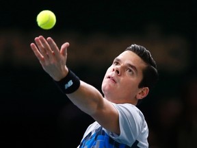 Milos Raonic serves during his match against Novak Djokovic at the Paris Masters at the Bercy sports hall in Paris, November 2, 2014. (REUTERS/Benoit Tessier)