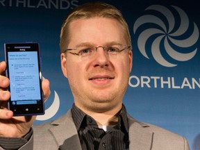 Local blogger Mack D. Male shows off the cellphone app for Northlands arena survey on his phone at Rexall Place in Edmonton, Alta., on Friday, Dec. 5, 2014. Ian Kucerak/Edmonton Sun