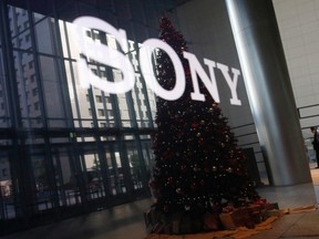 The logo of Sony Corp and a Christmas tree are reflected on the company's 4K television set at the company's headquarters in Tokyo November 18, 2014. (REUTERS/Toru Hanai)