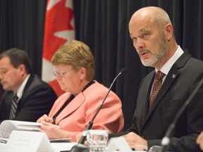 Chatham-Kent-Essex MP Dave Van Kesteren speaks at a news conference Friday in London outlining details of the federal government?s efforts to stop the spread of aquatic invasive species in the Great Lakes and Canadian waterways. Gail Shea, Minister of Fisheries and Oceans Canada, is at his right. (DEREK RUTTAN, The London Free Press)