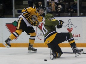 Troy Lajeunesse of the Sarnia Sting has his shot blocked by Ray Huether of the North Bay Battalion. Lajeunesse, who grew up in North Bay, scored against his hometown team as the Sting won 5-2 Friday night at RBC Centre. (TERRY BRIDGE, The Observer)