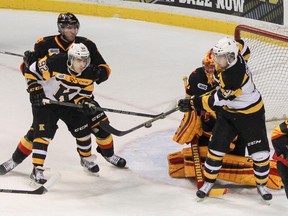 Kingston Frontenacs Corey Pawley, left, and Samuel Schutt both try to deflect the puck into the Belleville Bulls net during the first period of Ontario Hockey League action at the Rogers K-Rock Centre on Friday night. The Frontenacs won the game 2-1. (Julia McKay/The Whig-Standard)