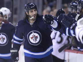 Winnipeg Jets forward Chris Thorburn celebrates his first-period goal against the Colorado Avalanche with teammates on the bench during NHL action at MTS Centre in Winnipeg, Man., on Fri., Dec. 5, 2014. Kevin King/Winnipeg Sun/QMI Agency