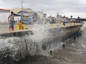 Waves, brought by Typhoon Hagupit, hit the concrete barrier along the Boulevard Seaport in Surigao City, southern Philippines Dec. 6, 2014.  REUTERS/Erwin Frames