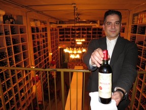 The host-with-the-most. Maitre'd Pat Orgera proudly displays the prize of Barberian's Steak House 40,000-bottle wine cellar, a 1982 Petrus offered for $17,465. I'm thinking, no wonder it hasn't sold.