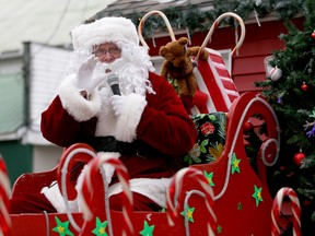 Santa waves to the crowds in Wellington, ON., during the parade Saturday, Dec. 6, 2014. 
EMILY MOUNTNEY-LESSARD/THE INTELLIGENCER/QMI AGENCY