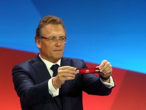 FIFA Secretary General Jerome Valcke displays USA's slip during the FIFA Women's World Cup Canada 2015 tournament final draw held at the Canadian Museum of History in Gatineau, Canada, on Dec. 6, 2014.