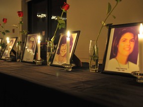 Candles line a table in front of photos of the 14 women killed at Montreal's Ecole Polytechnique in this file photo from the Brockville Rowing Club in 2013 in Brockville, Ont. Brockville Recorder and Times/QMI Agency