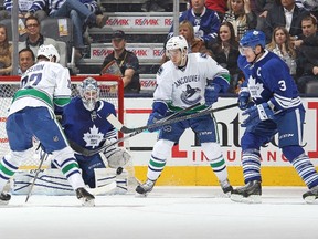 Vancouver Canucks' Daniel Sedin tries to control the puck in front of Maple Leafs goalie Jonathan Bernier on Saturday night at the Air Canada Centre. (GETTY IMAGES)