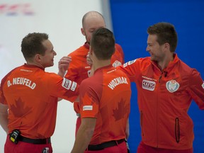 Mike McEwen, right, celebrates Saturday`s extra-end win over Glenn 
Howard with his team at the Canada Cup in Camrose. (Michael Burns, CCA)