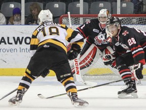 Kingston Frontenacs Robert Polesello takes a hard shot on Niagara Ice Dogs goaltender Brandon Hope, which he catches, during the first period of Ontario Hockey League action at the Rogers K-Rock Centre in Kingston, Ont. on Saturday, December 6, 2014. JULIA MCKAY/Kingston Whig-Standard/QMI Agency