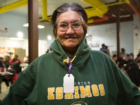 Helen Hebert tries on her new Edmonton Eskimos hoodies donated to her at Boyle Street Community Services during Hoodies for the Homeless in Edmonton, Alta., on Saturday, Dec. 6, 2014. The charity is in organizer Megan Lee's brother Craig's memory. One thousand pieces of warm clothes were handed out by volunteers on Saturday. Ian Kucerak/Edmonton Sun/ QMI Agency