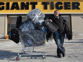 Ron Pitre poses for a photo in front of Giant Tiger in Ottawa Friday Dec 5, 2014. Ron is a musician who has organized a concert fundraiser for the Shepherds of Good Hope on Christmas Eve. Three hundred backpacks which will be filled with goodies will be given out during the concert. 
Tony Caldwell/Ottawa Sun/QMI Agency