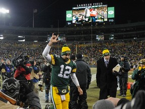 Green Bay Packers quarterback Aaron Rodgers (12) runs off the field  after the Packers beat the New England Patriots 26-21 at Lambeau Field on Nov 30, 2014 in Green Bay, WI, USA. (Benny Sieu/USA TODAY Sports)