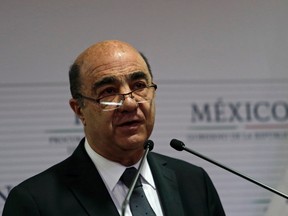 Attorney General Jesus Murillo speaks during a news conference at the attorney general's office in Mexico City December 7, 2014. Mexican authorities on Sunday said that mounting evidence and initial DNA tests confirmed that 43 trainee teachers who were abducted by corrupt police 10 weeks ago were incinerated at a garbage dump by drug gang members. Murillo told reporters that one of the students had been identified by experts in Austria from a bone fragment in a bag of ash and bits of burned tire found in a river where drug gang members said they tossed the students remains. REUTERS/Carlos Jasso