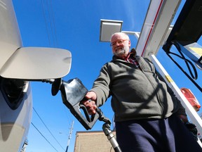 Jens Karl fills up at a Top Valu on Kingston Rd in Toronto for $1.01 per litre on Sunday. (MICHAEL PEAKE, Toronto Sun)