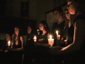 Nearlhy 200 people share candles in memory of women who have lost their lives in gender-based violence during the local National Day of Remembrance and Action on Violence Against Women memorial and candlelight vigil at Sydenham Street United Church on Saturday. (Julia McKay/The Whig-Standard)