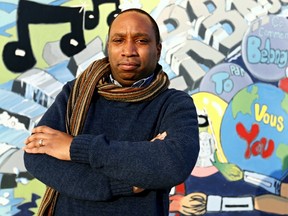Rawlson King, president of the Overbrook Community Association, poses for a photograph in front of a mural at the associations' building. Saturday Dec. 7, 2014. Errol McGihon/Ottawa Sun/QMI Agency